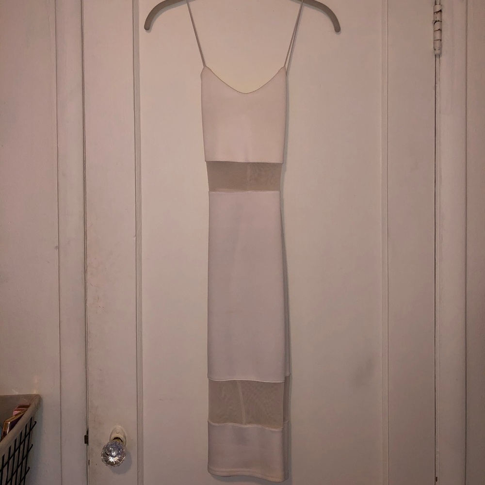 Tight white mini dress with sheer panels